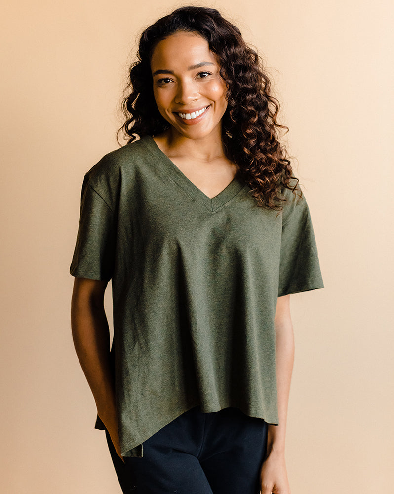 Stylish nursing mother wearing a heather green maternity shirt for breastfeeding