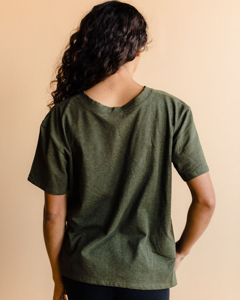 Fashionable nursing mother in a heather green maternity shirt for breastfeeding